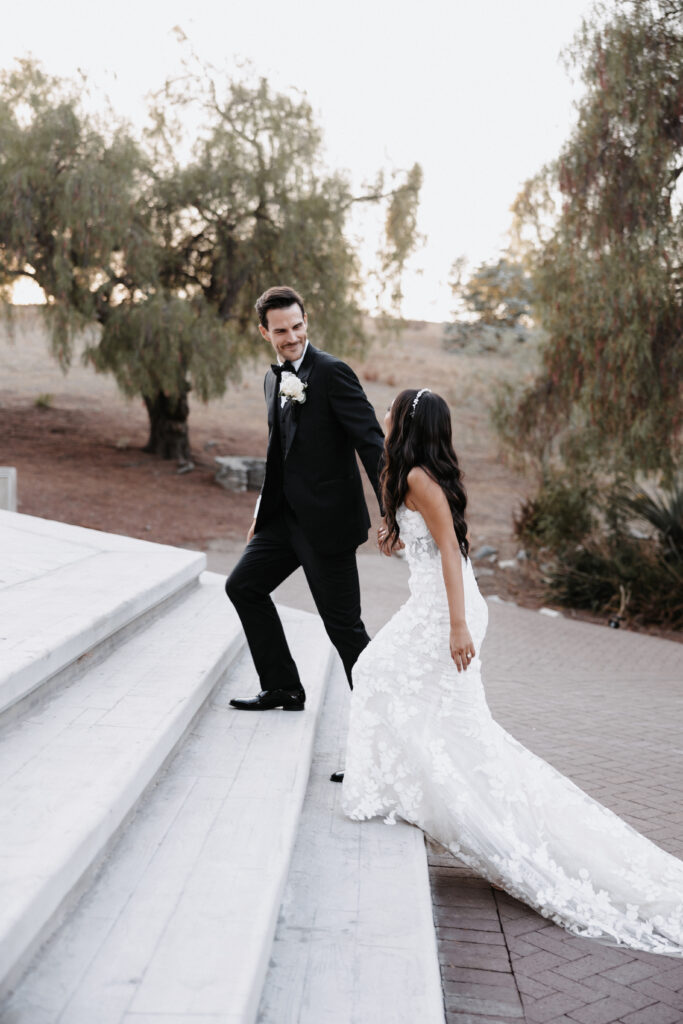 Wedding couple walking up stairs prompt posing