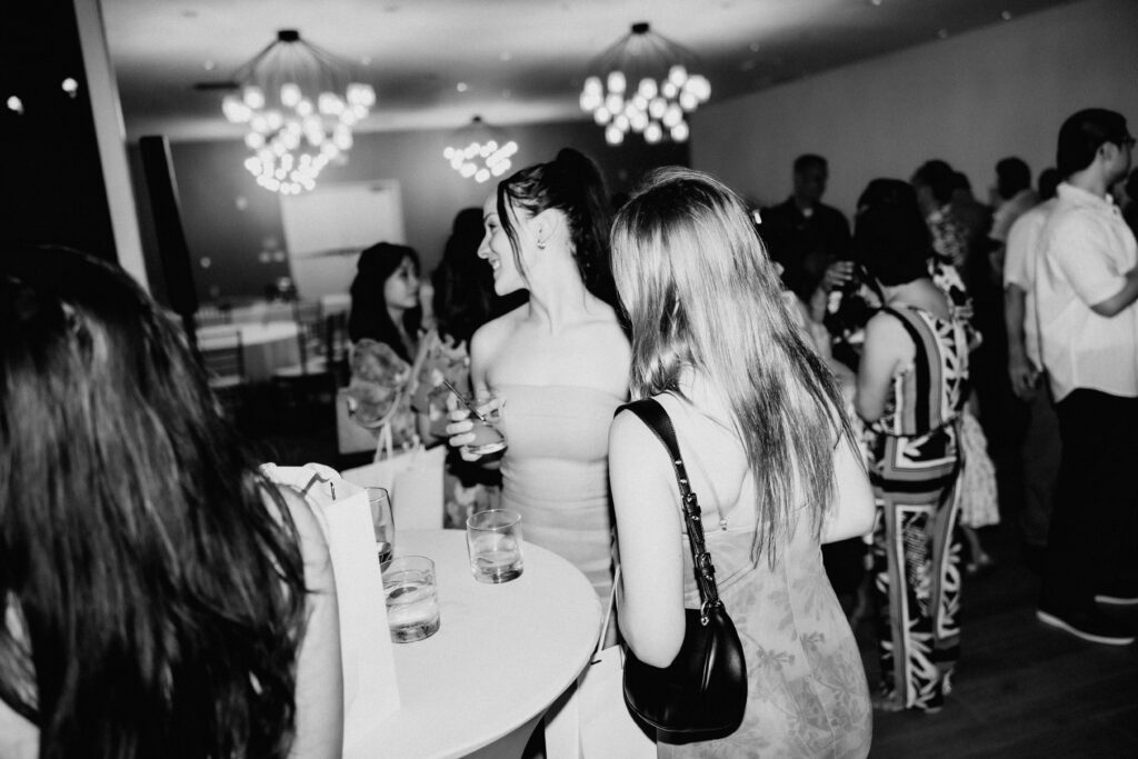 Film photography of friends enjoying a wedding reception at Queen Kapiolani The Deck