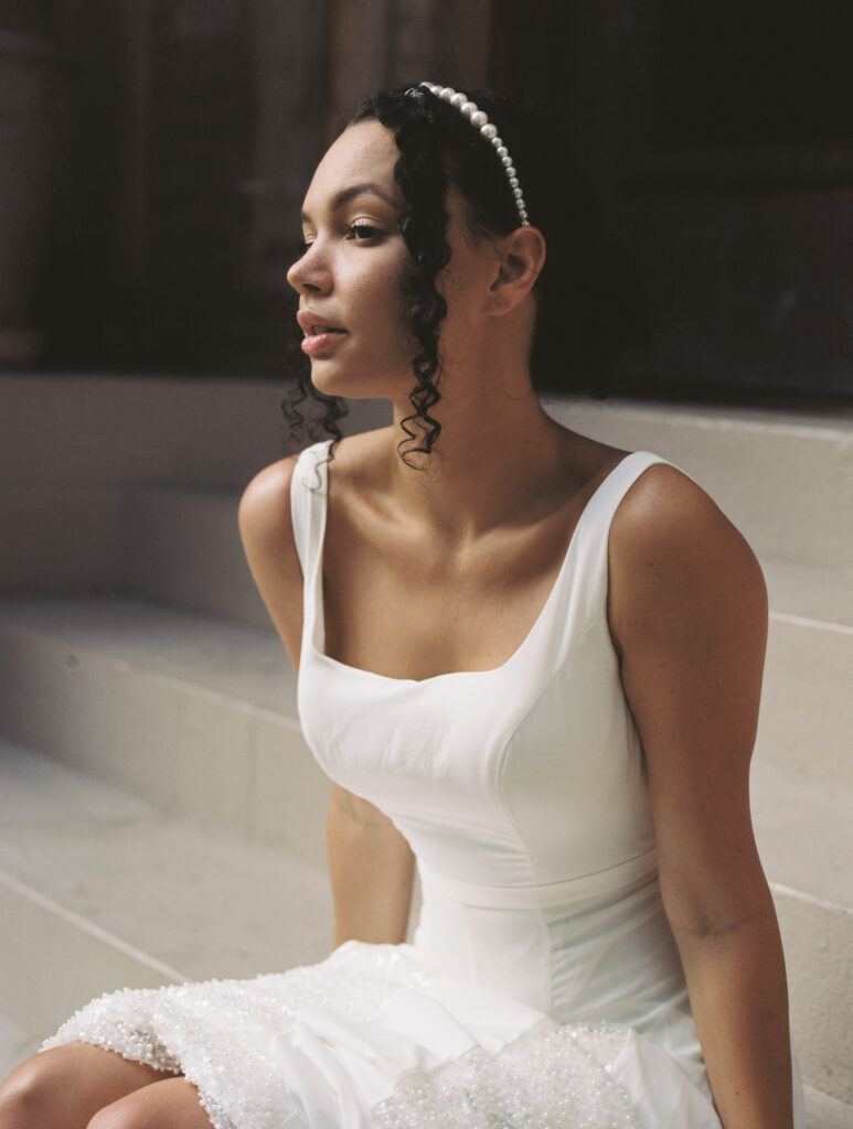 35mm bridal portrait of bride in modern wedding dress with pearl headband