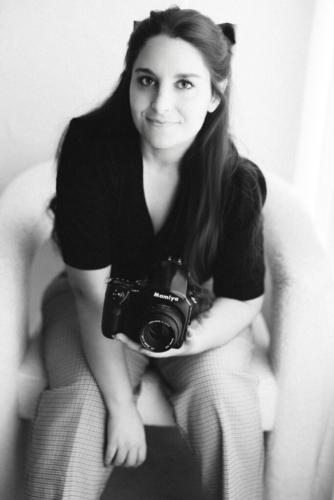 Amari Marie black and white studio headshot holding Mamiya film camera