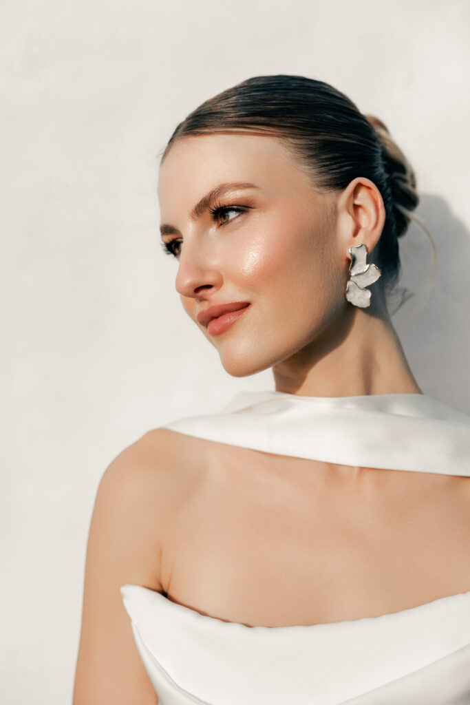 Elegant bridal portrait with soft natural lighting, bride in strapless wedding dress looking away from camera